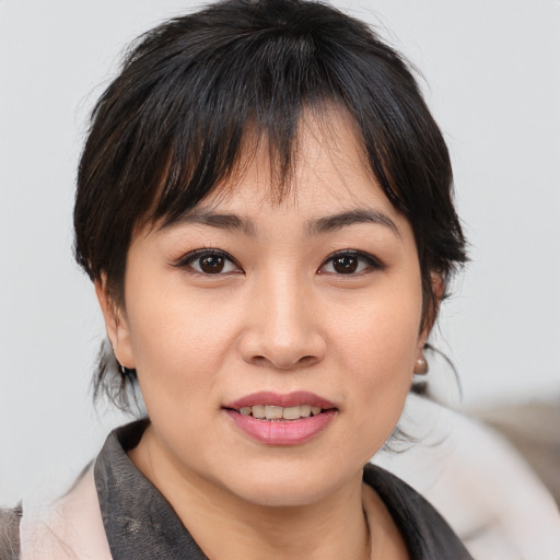 Joyful asian young-adult female with medium  brown hair and brown eyes