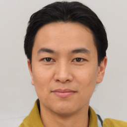 Joyful asian young-adult male with short  brown hair and brown eyes