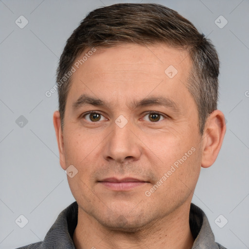 Joyful white adult male with short  brown hair and brown eyes