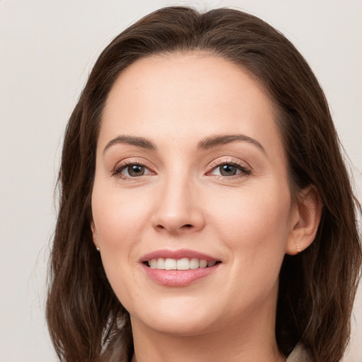 Joyful white young-adult female with long  brown hair and grey eyes