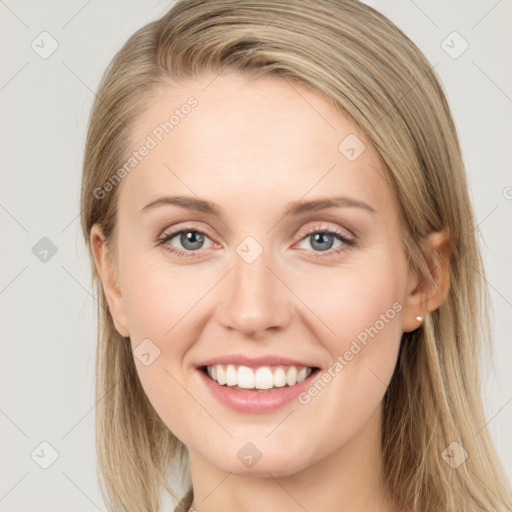 Joyful white young-adult female with long  brown hair and blue eyes