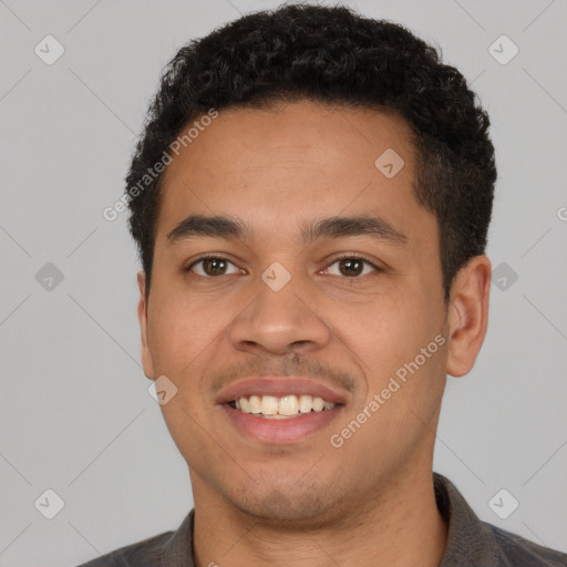 Joyful latino young-adult male with short  brown hair and brown eyes