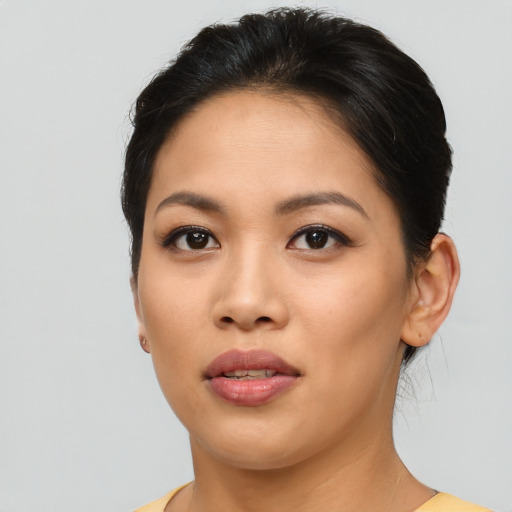 Joyful asian young-adult female with short  brown hair and brown eyes
