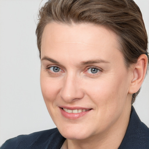 Joyful white adult female with short  brown hair and grey eyes