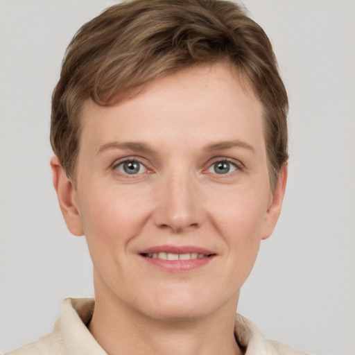 Joyful white young-adult female with short  brown hair and grey eyes