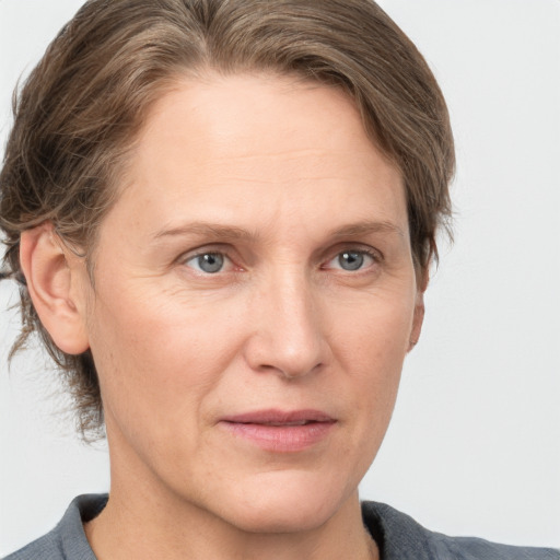 Joyful white adult female with medium  brown hair and grey eyes