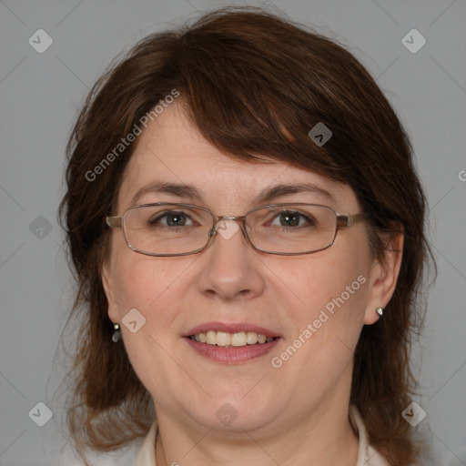 Joyful white adult female with medium  brown hair and blue eyes