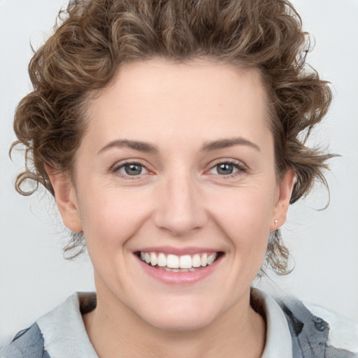 Joyful white young-adult female with medium  brown hair and blue eyes