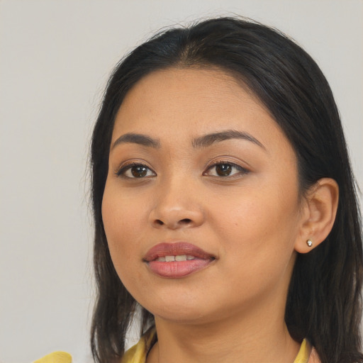 Joyful asian young-adult female with long  black hair and brown eyes