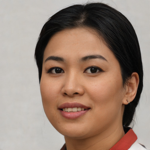 Joyful asian young-adult female with medium  brown hair and brown eyes