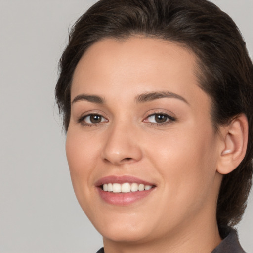 Joyful white young-adult female with medium  brown hair and brown eyes