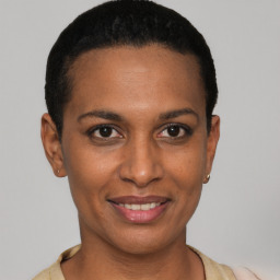 Joyful black young-adult female with short  black hair and brown eyes