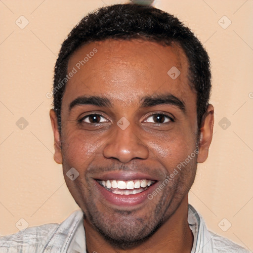 Joyful black young-adult male with short  black hair and brown eyes