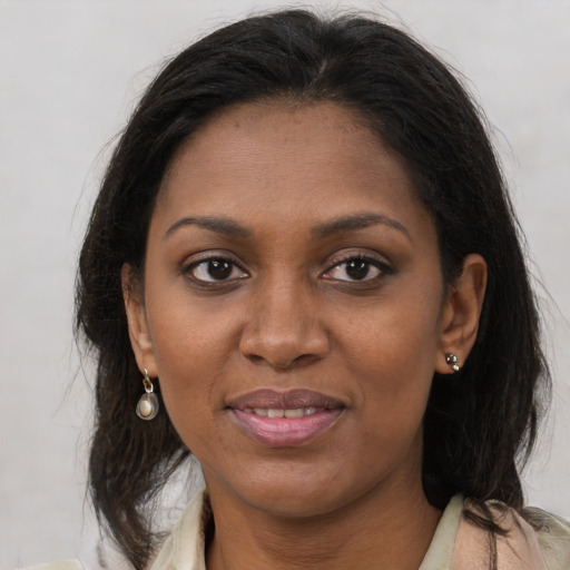 Joyful black young-adult female with medium  brown hair and brown eyes
