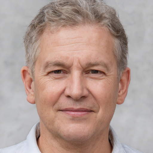 Joyful white middle-aged male with short  brown hair and brown eyes