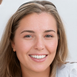 Joyful white young-adult female with long  brown hair and blue eyes