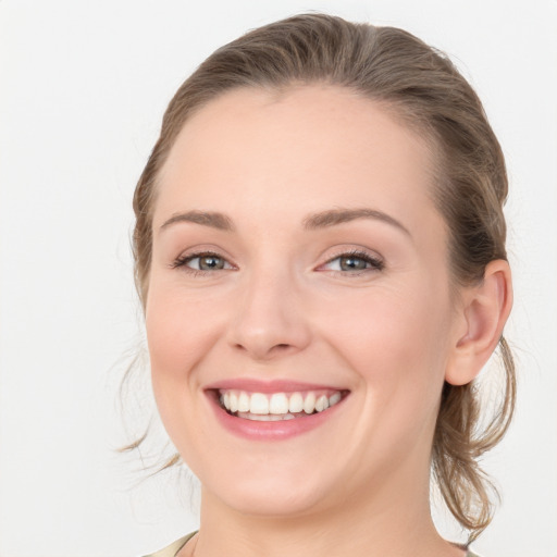 Joyful white young-adult female with medium  brown hair and blue eyes