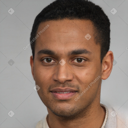 Joyful black young-adult male with short  brown hair and brown eyes