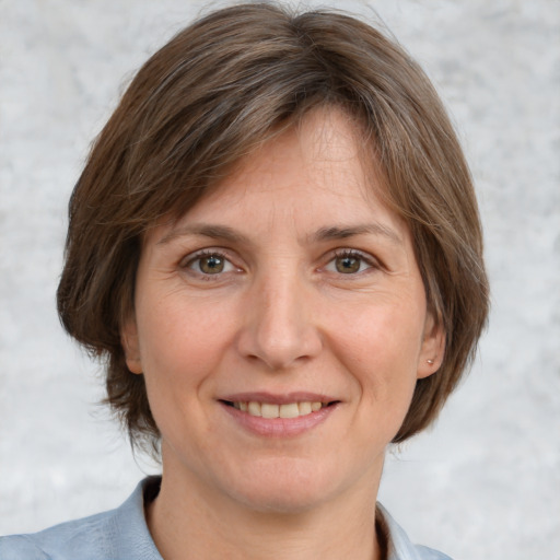 Joyful white adult female with medium  brown hair and grey eyes