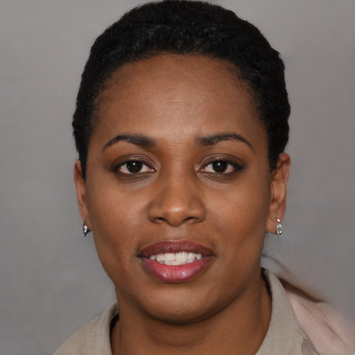 Joyful black young-adult female with short  black hair and brown eyes
