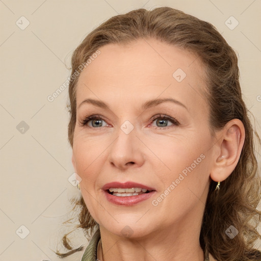 Joyful white adult female with medium  brown hair and blue eyes