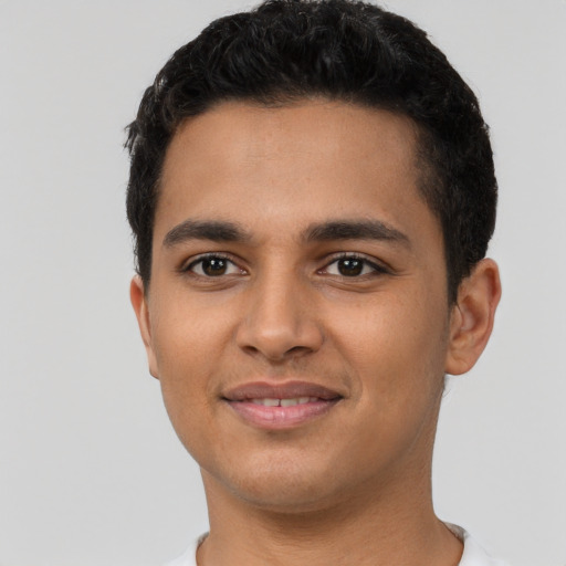 Joyful latino young-adult male with short  black hair and brown eyes