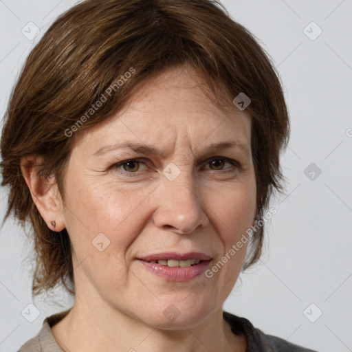 Joyful white adult female with medium  brown hair and grey eyes