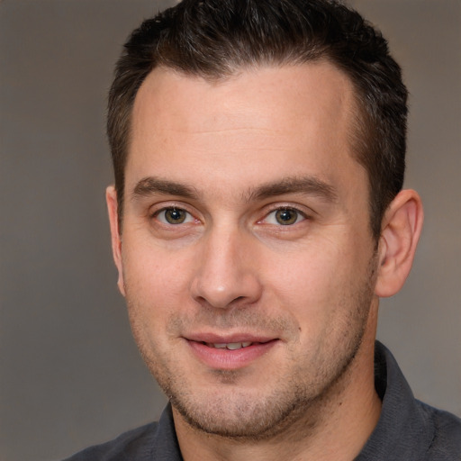 Joyful white adult male with short  brown hair and brown eyes