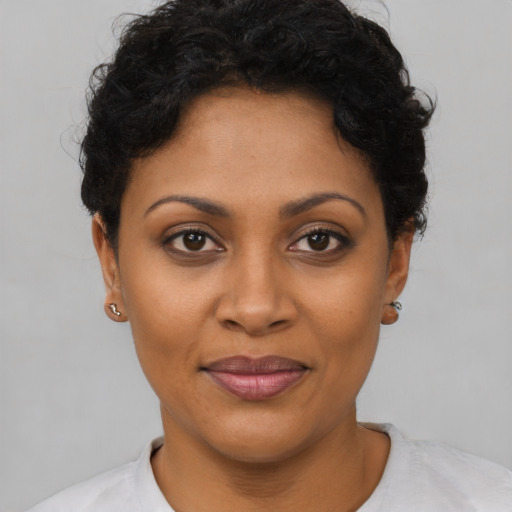 Joyful latino young-adult female with short  brown hair and brown eyes