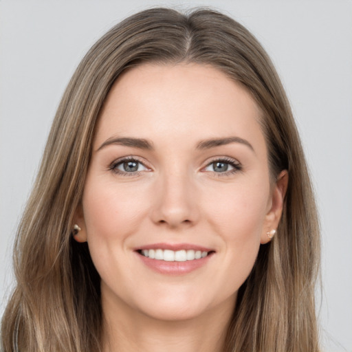 Joyful white young-adult female with long  brown hair and grey eyes