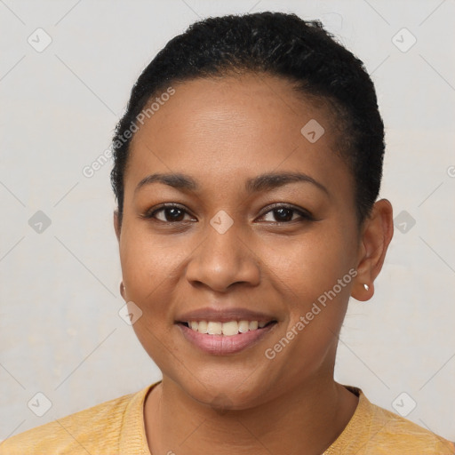 Joyful black young-adult female with short  black hair and brown eyes