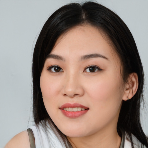 Joyful asian young-adult female with long  black hair and brown eyes