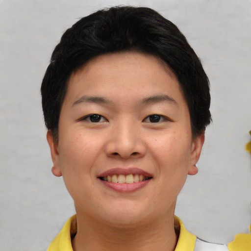 Joyful asian young-adult female with short  brown hair and brown eyes
