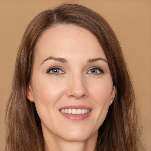 Joyful white young-adult female with long  brown hair and brown eyes