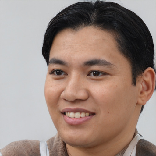 Joyful asian young-adult male with short  brown hair and brown eyes