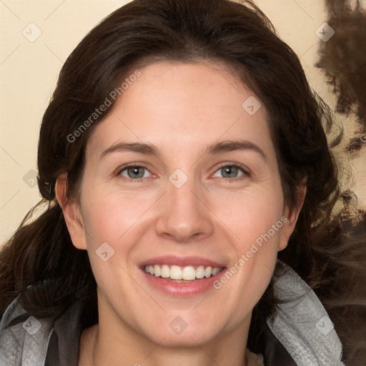 Joyful white adult female with medium  brown hair and grey eyes