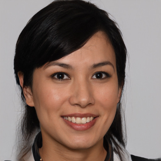 Joyful white young-adult female with medium  black hair and brown eyes