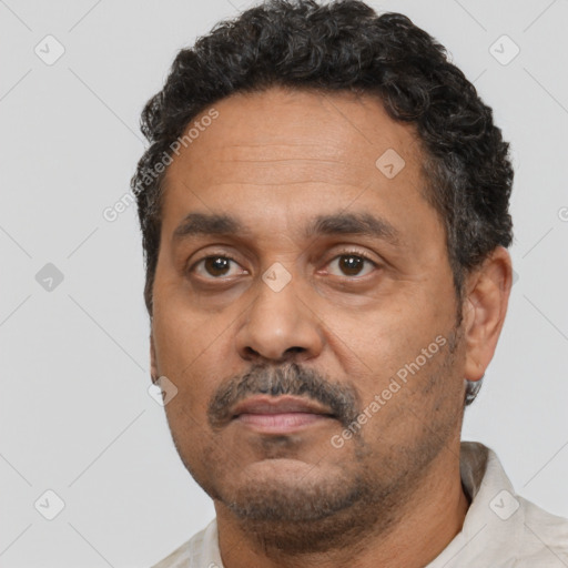 Neutral black adult male with short  black hair and brown eyes