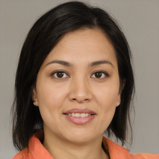 Joyful asian young-adult female with medium  brown hair and brown eyes