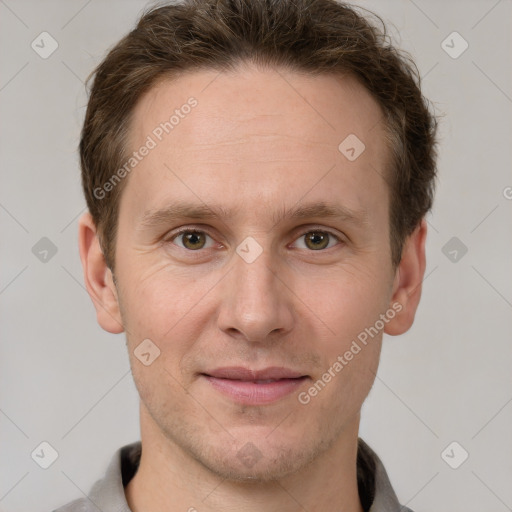 Joyful white adult male with short  brown hair and grey eyes