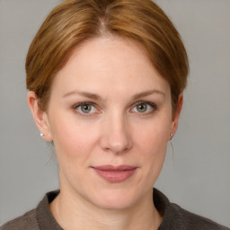 Joyful white adult female with medium  brown hair and blue eyes