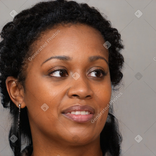 Joyful black adult female with long  brown hair and brown eyes