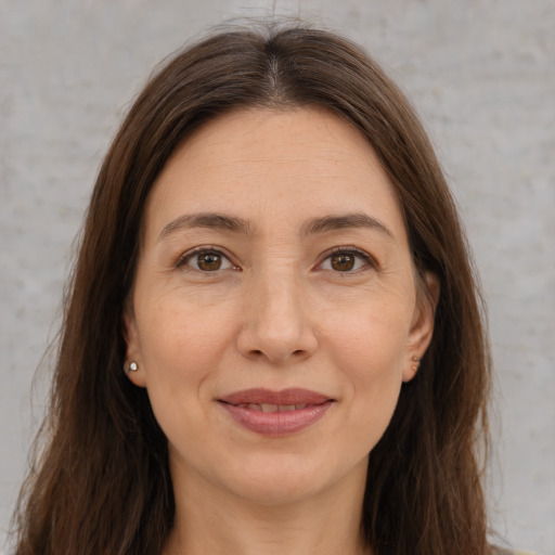 Joyful white adult female with medium  brown hair and brown eyes
