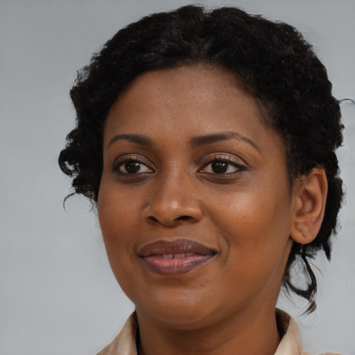 Joyful black young-adult female with medium  brown hair and brown eyes