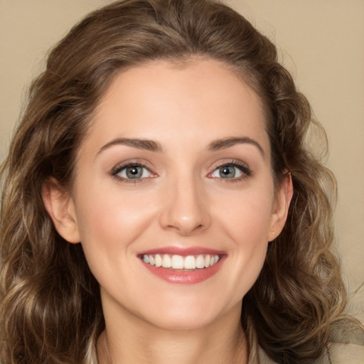 Joyful white young-adult female with long  brown hair and green eyes