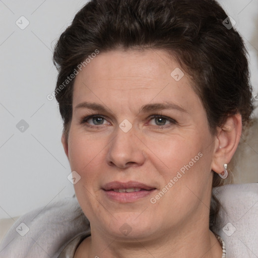 Joyful white adult female with short  brown hair and brown eyes