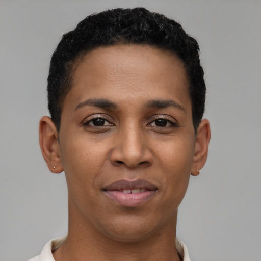 Joyful latino young-adult male with short  brown hair and brown eyes