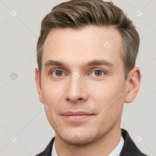 Joyful white young-adult male with short  brown hair and grey eyes