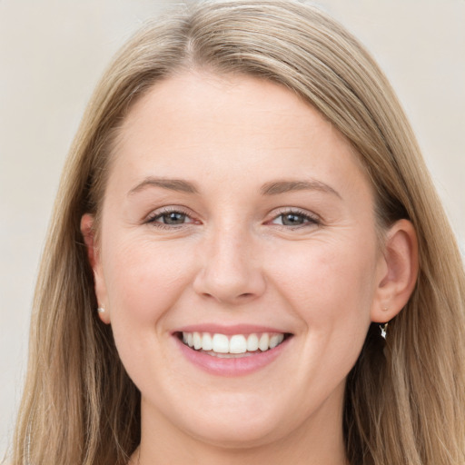 Joyful white young-adult female with long  brown hair and blue eyes