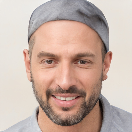 Joyful white adult male with short  black hair and brown eyes